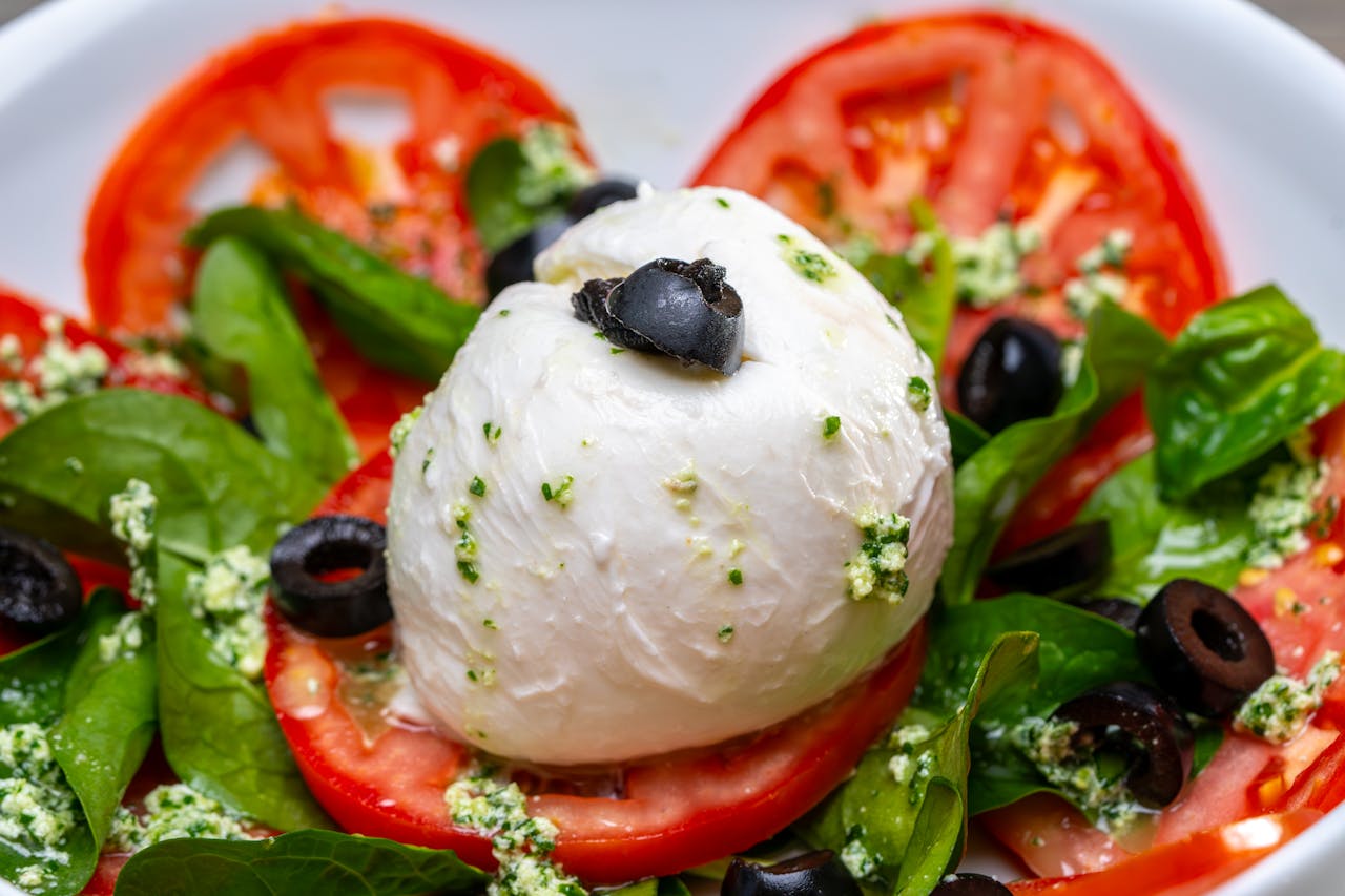 Delicious Caprese salad with mozzarella, tomatoes, and olives.